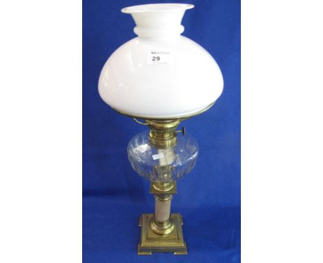 Early 20th Century oil lamp with thumb cut clear glass reservoir on brass pedestal base with white glass shade.