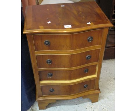 Reproduction yew wood narrow serpentine fronted chest of four drawers on bracket feet.