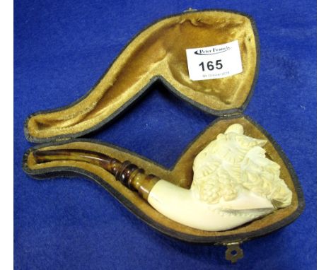 Carved Meerschaum portrait pipe depicting a Bacchanalian bearded figure with vine leaves in his hair, having amber stem.  Cas