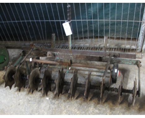 Lawn aireator and scarifier, to be towed by garden tractor or mower.
