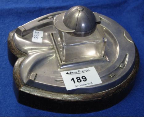 Daniel and Arter silver plated, horse shoe shaped, inkwell stand with glass inkwell having jockey cap hinged cover.
