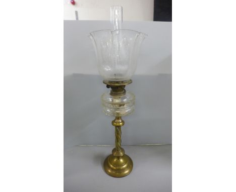 A brass and glass oil lamp **PLEASE NOTE THIS LOT IS NOT ELIGIBLE FOR IN-HOUSE POSTING AND PACKING** 