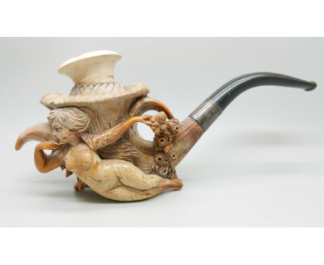 A large carved Meerschaum pipe of a lady reclining holding a bouquet of flowers, plated collar and black stem, cased 