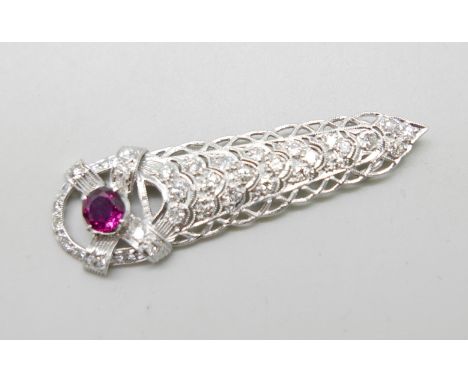 A white metal pendant set with diamonds and a ruby in an Art Deco style setting, 5.6g, 52mm