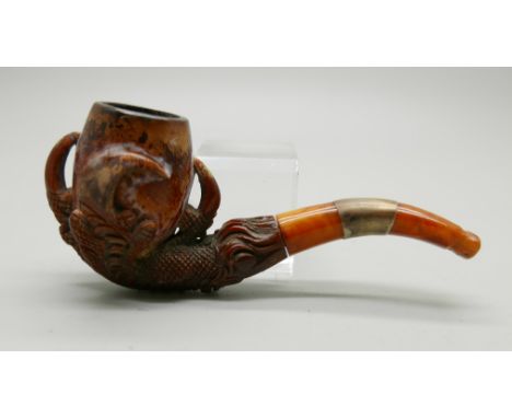 A carved Meerschaum pipe in the form of an eagle's claw with amber stem, cased 