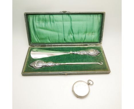A silver mounted button hook and shoe horn and a silver fob watch 