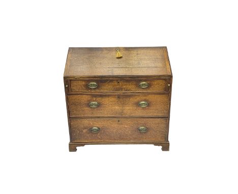George III oak bureau, fall front enclosing fitted interior, above three graduating drawers with cockbeaded fronts, on bracke