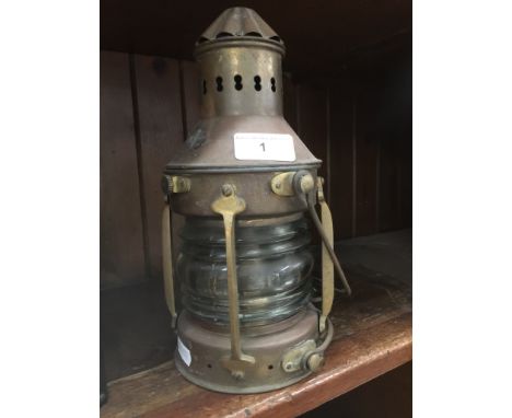 A brass ships lanternThe lantern has the original burner inside, the burner has "Nauticalia" mark on the bottom.