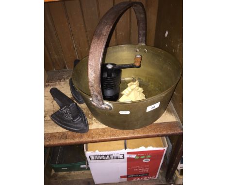 A large brass jam pan, 2 flat irons, a crinoline lady door stop, a small hand scale and a vintage coffee grinder. 