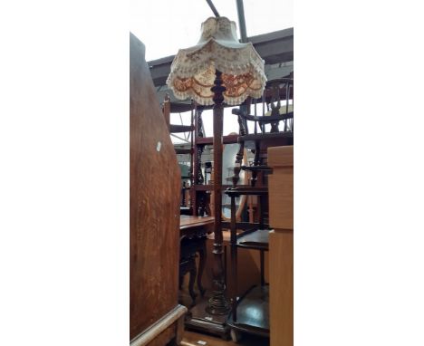 An early 20th century oak standard lamp. 