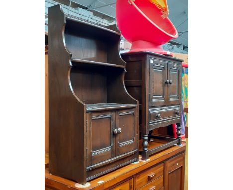 An Ercol dark elm cabinet bookcase and an Ercol dark elm side cabinet. 