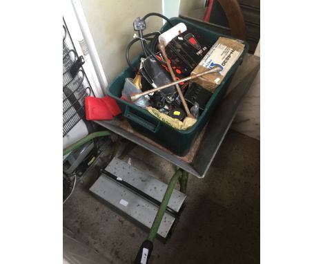A wheelbarrow, a box of tools and other misc items and a metal toolbox with tools. 