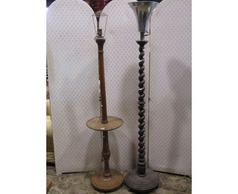 A beechwood lamp standard on tapering barley twist column and platform base and a further example in pale beechwood 