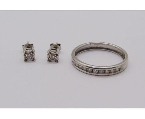 9ct white gold channel set diamond ring, size N/O and a pair of 9ct white gold diamond stud earrings, 2.6g total (3) 