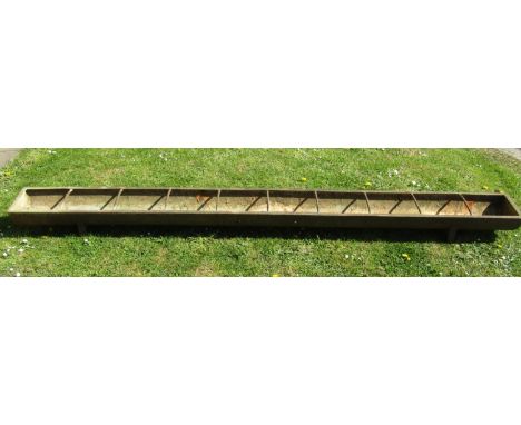 A vintage cast iron rectangular pig feeding trough with nine rung divisions and plaque to interior H G Phipps, Chippenham, 30
