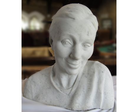 A 20th century marble bust of a woman, initialled R C to the back. 40cm wide x 42cm high. 