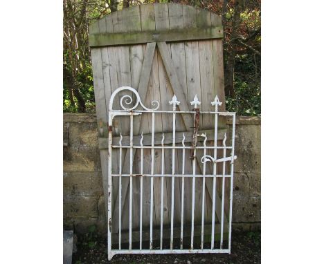 A good quality heavy gauge iron work pedestrian gate with vertical square cut and wavy bars, scroll detail, spear head finial