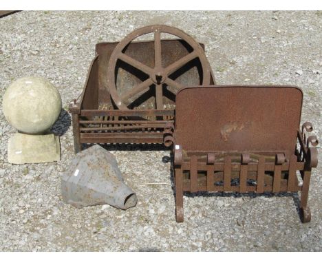 Two weathered cast iron fire baskets of varying design, a vintage iron six spoke implement wheel, 42 cm in diameter, a weathe