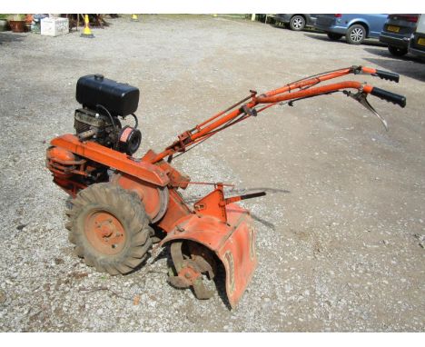 A Howard petrol driven garden rotovator with Kohler engine together with varying plough and rotor attachments 