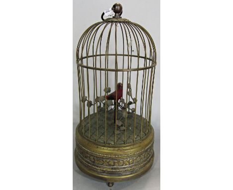 A 19th century singing bird automaton within a brass cage, 28cm high. (in working order) 