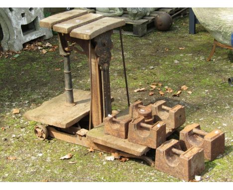 A Bartlett Bristol cast iron sack scale with elm boards to weigh 3 CWT, together with a selection of associated weights (af) 