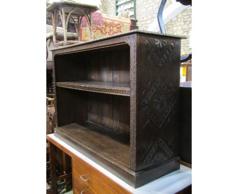 Late 19th century open oak bookcase with single shelf within repeating geometric carved detail, 130 cm wide 