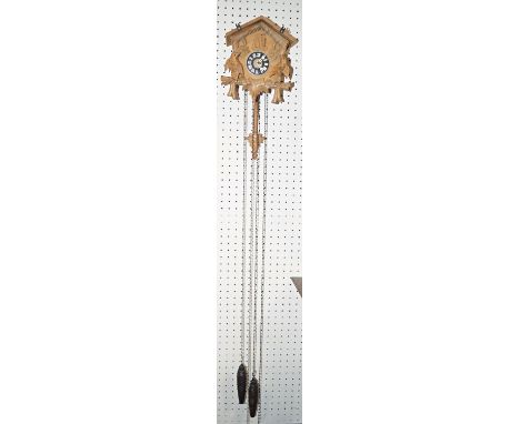 A small traditional Tyrolean carved softwood cuckoo clock, with pine cone shaped weights 