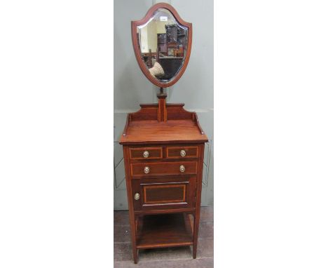 An inlaid Edwardian mahogany gentleman's shaving stand, the base enclosed by an arrangement of drawers, cupboard and lower sh