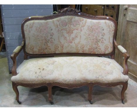 A French drawing room sofa with carved and moulded showwood frame, floral and other detail upholstered in an aubusson style f