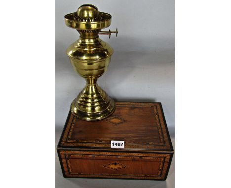 A 19th century rosewood box with fruitwood and ebony chevron inlay and the brass base of an oil lamp. 