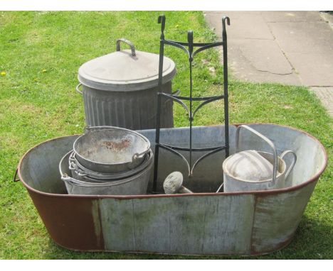 A weathered vintage two handled galvanised tin bath of oval tapered form together with a stack of heavy gauge galvanised buck