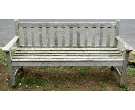 An R A Lister &amp; Co Ltd weathered teak two seat garden bench with slatted seat and back, 130 cm wide 