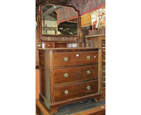 An Edwardian mahogany dressing chest of three long drawers beneath a raised swing mirror with bevelled edge plate over two tr