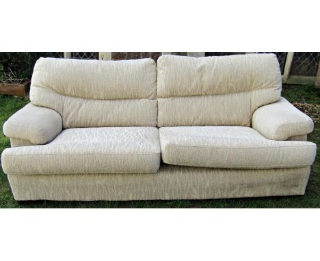 A three seat sofa, cream ground with repeating reed patterned upholstery, with loose squab cushions, 210cm long, together wit