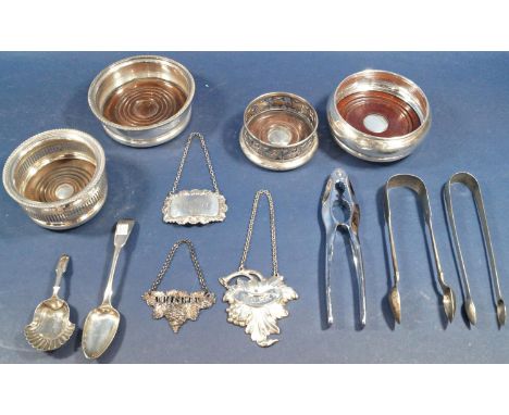 A mixed lot of silver and silver plate comprising four coasters, caddy spoon, three drinks labels, two sugar tongs, a teaspoo