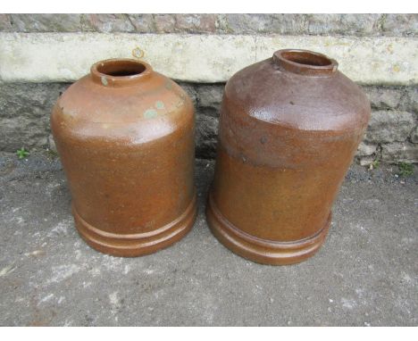 A vintage salt glazed stoneware bell shaped rhubarb forcer 51 cm high, together with a similar smaller example 46 cm high 