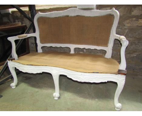 A French sofa frame with carved and moulded outline waiting re-upholstery 