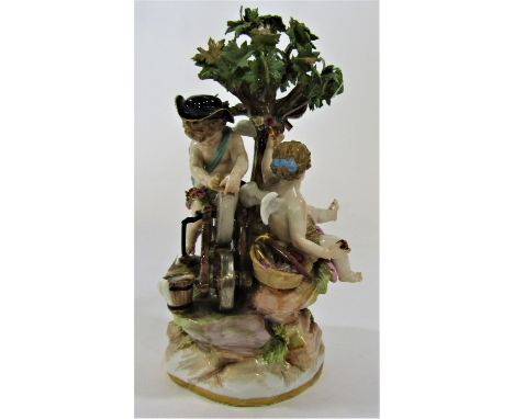 A Meissen porcelain Cupid sharpening his arrows alongside Psyche inspecting an arrow beneath a tree, blue crossed swords to t