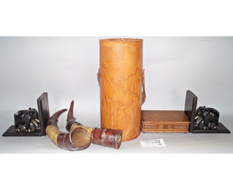 A miscellaneous collection of items including, a musical cigarette box, a pair of leather clad cow horns, a pair of hardwood 