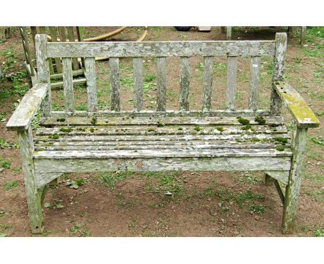 A vintage weathered Burma teakwood three seat garden bench with slatted seat, back and tapered arms, 158 cm long 