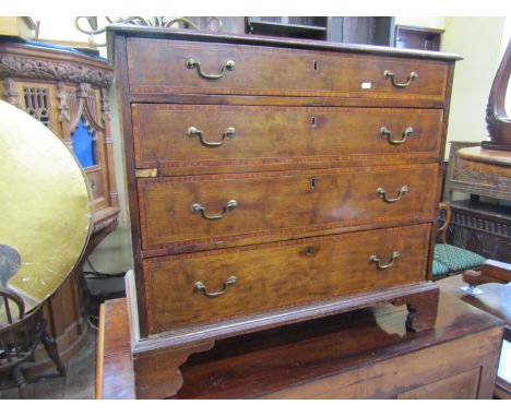 A small inlaid Edwardian mahogany chest of four long graduated drawers crossbanded in satinwood raised on bracket supports, 8