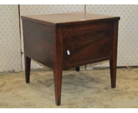 A Georgian mahogany box commode with rising lid and original fitted interior on swept supports 