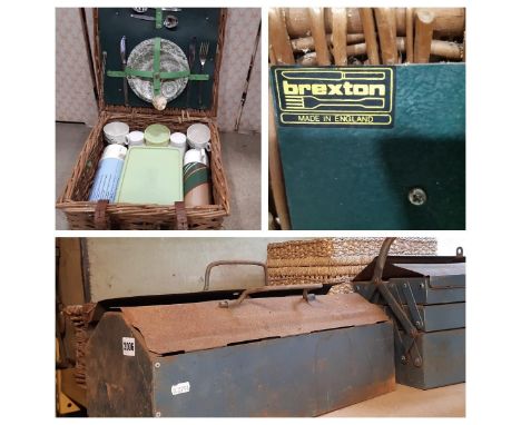 A vintage green canvas leather overlaid travel trunk and a wicker picnic basket, two tool chests with contents, etc 