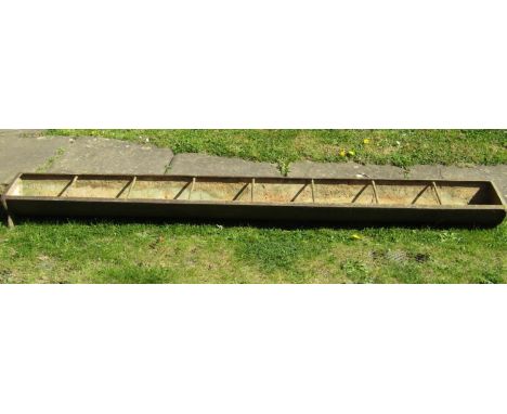 A vintage cast iron rectangular pig feeding trough with seven rung divisions 244 cm (8 ft) long x 31 cm wide (1 ft) 