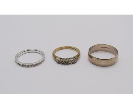 9ct wedding ring, size U, 2.6g, a 9ct diamond set ring, size P, 2.7g and a further Swarovski costume example (one stone vacan
