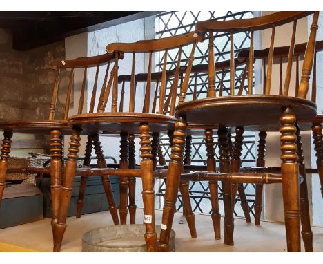 A set of six Swedish stick back kitchen chairs each with circular seats 