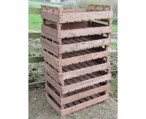 A stack of eight vintage rectangular wooden potato trays, some with printed lettering R. Chester &amp; W E Franklin, 76 cm lo