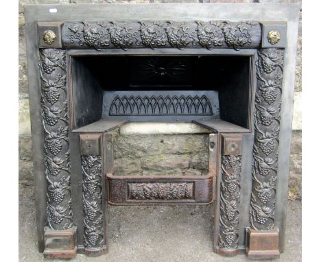 A Regency cast iron fire grate/surround with trailing fruiting vine detail, 95cm x 95cm 