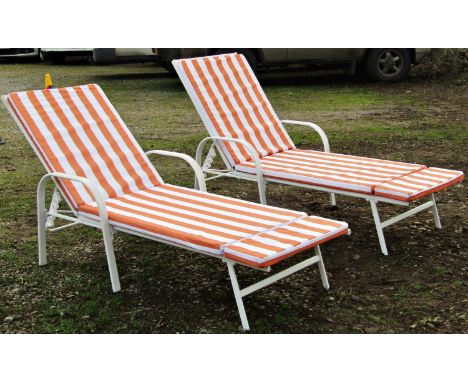 A pair of contemporary painted light steel framed garden or poolside loungers with adjustable backs 