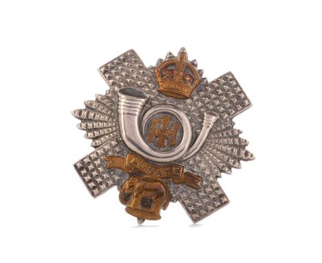 EARLY 20TH CENTURY HIGHLAND LIGHT INFANTRY WHITE METAL CAP BADGE,with enamel and brass mounts, 5.3cm high